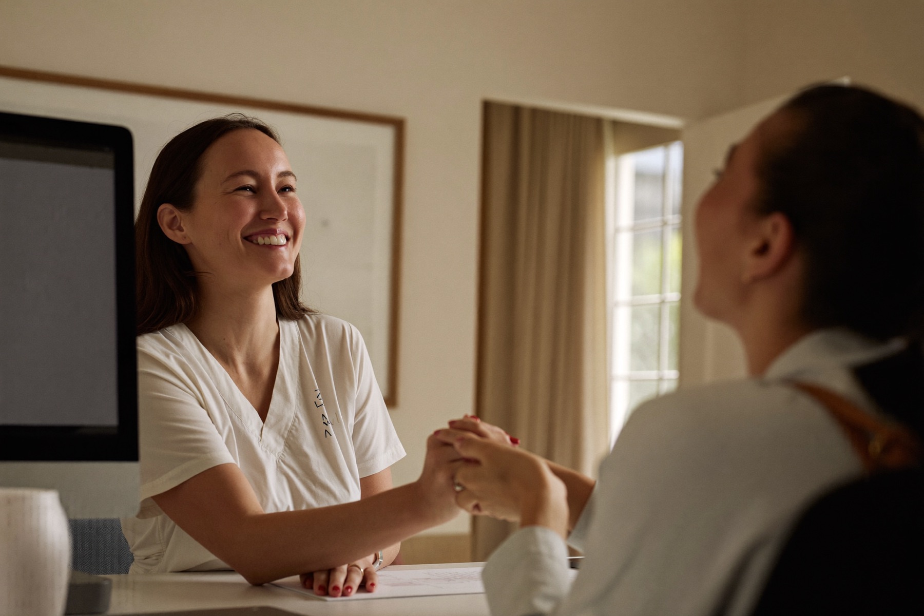 A business owner welcoming a happy client